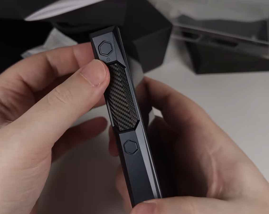 FiiO M23 left side panel showing power button and carbon-fiber textured touch volume slider