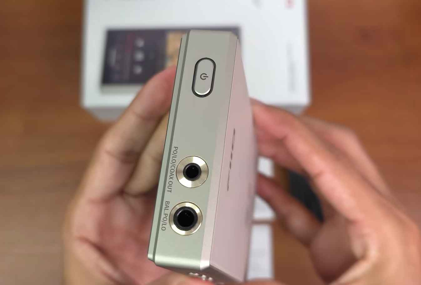 FiiO M33 R2R top panel showing 3.5mm single-ended, 4.4mm balanced headphone jacks, and power button