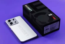 Lenovo Legion Y70 white edition smartphone resting beside its official black retail packaging box