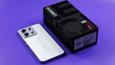 Lenovo Legion Y70 white edition smartphone resting beside its official black retail packaging box