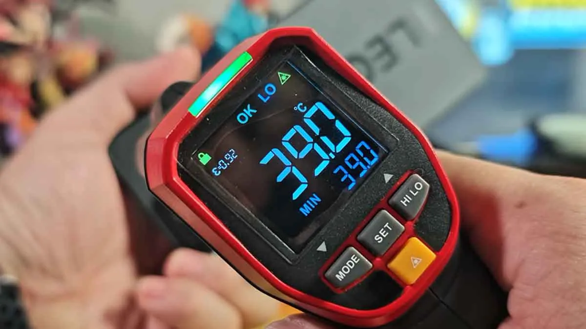 Infrared thermometer testing Lenovo Legion Y70 surface temperature measuring a cool 39 degrees Celsius after gaming